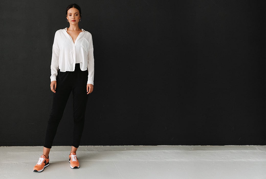 Womean wearing orange Saucony Shadow shoes.