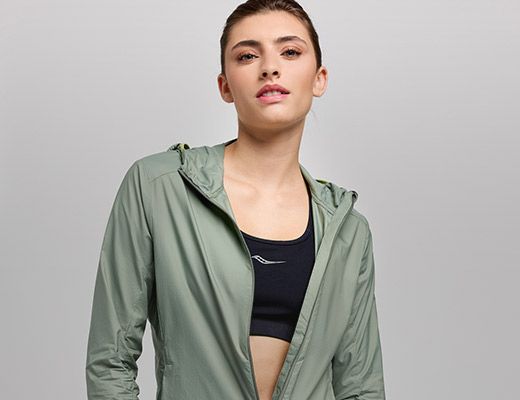 A person in a green Saucony jacket.