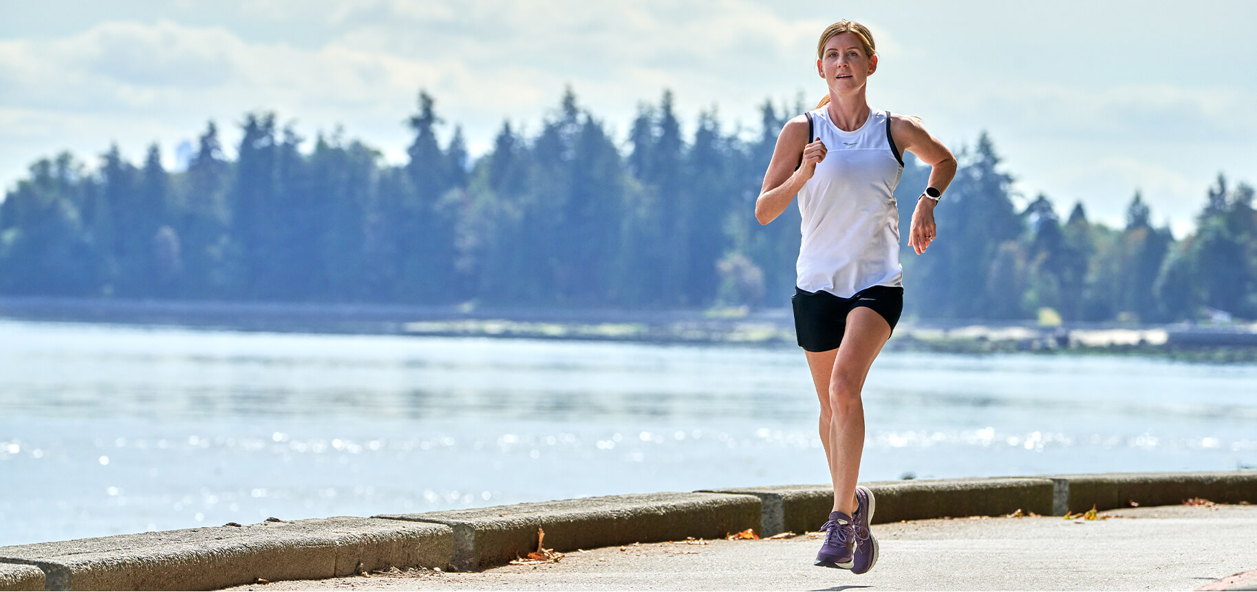 Steph McGregor running by a breakwall.