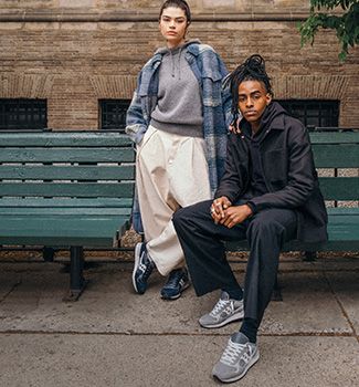 Two people sitting on a bench.