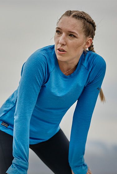 A person in a blue Saucony shirt.