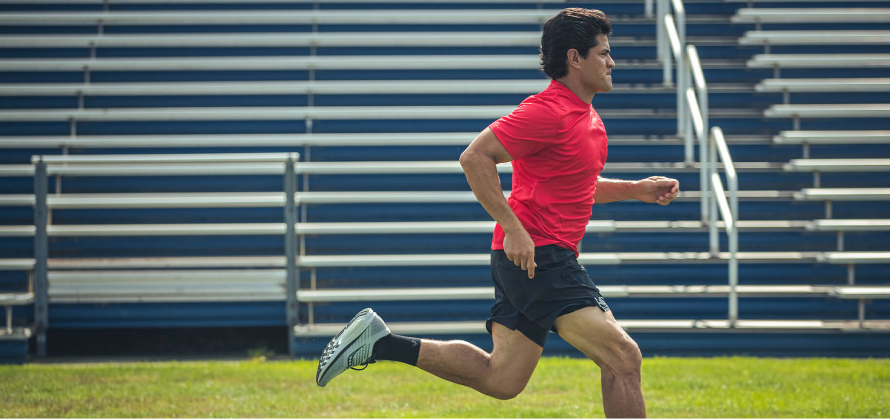 Tedy Bruschi running on a track.