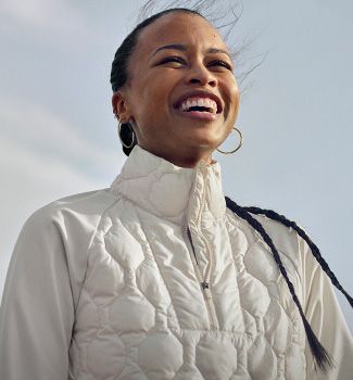 A person in a white Saucony jacket.