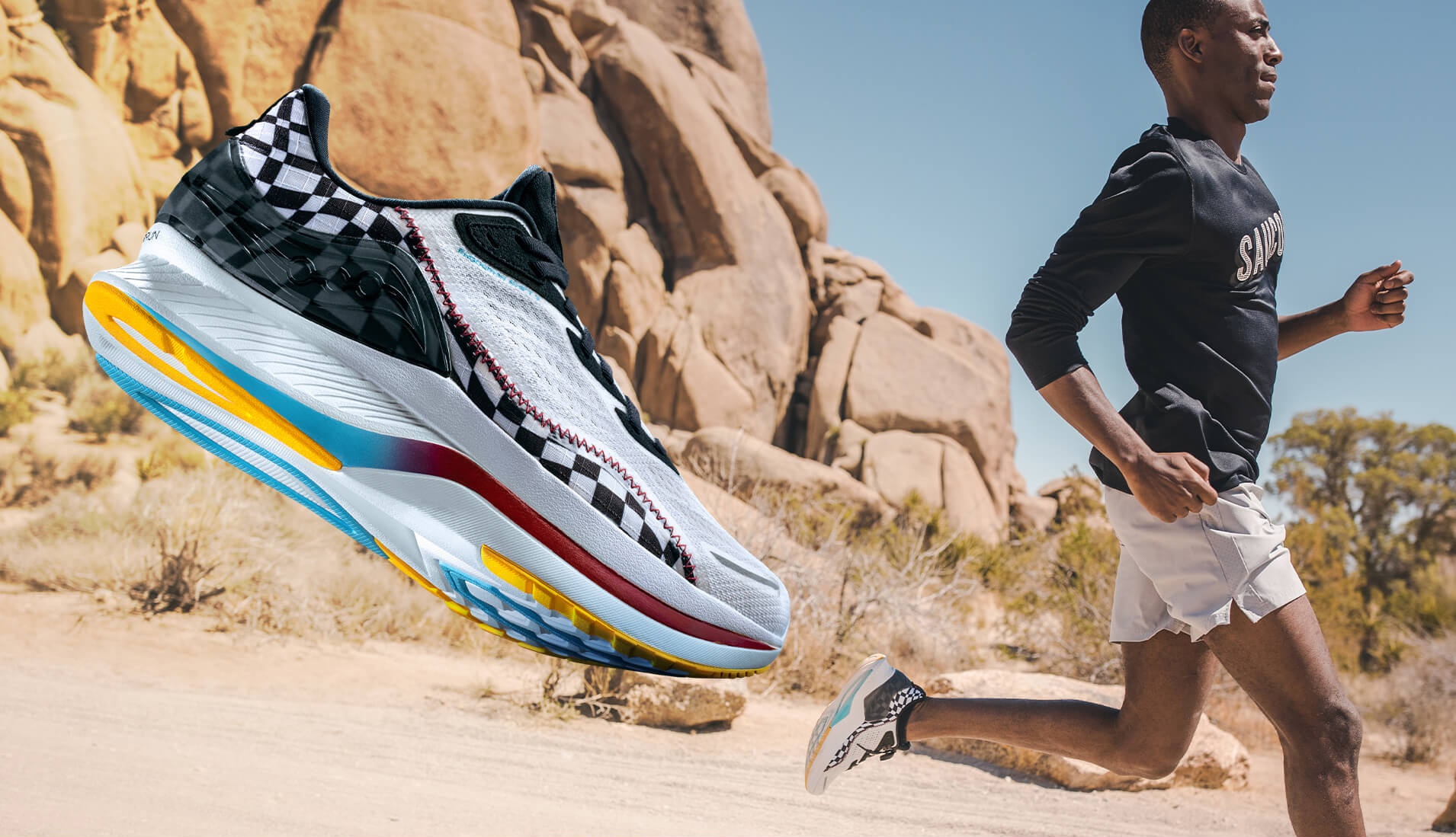 Runner passing by huge desert boulders.