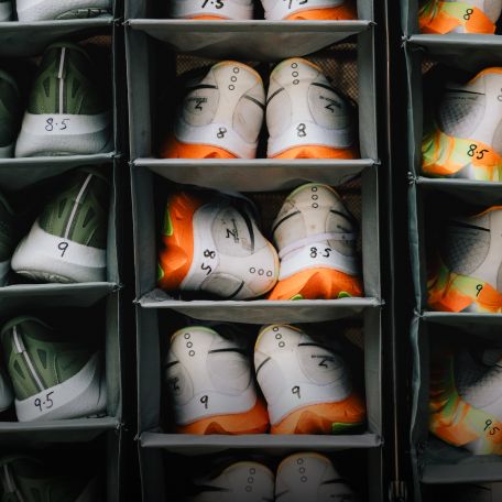 a group of shoes in a shoe rack