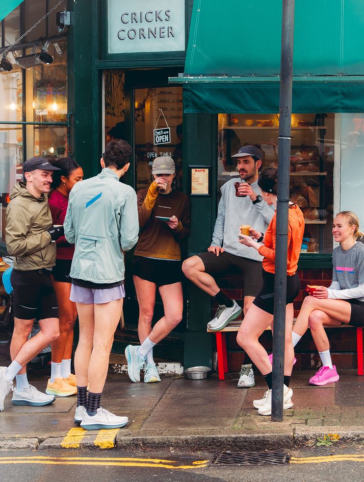a group of people sitting on a bench outside a building