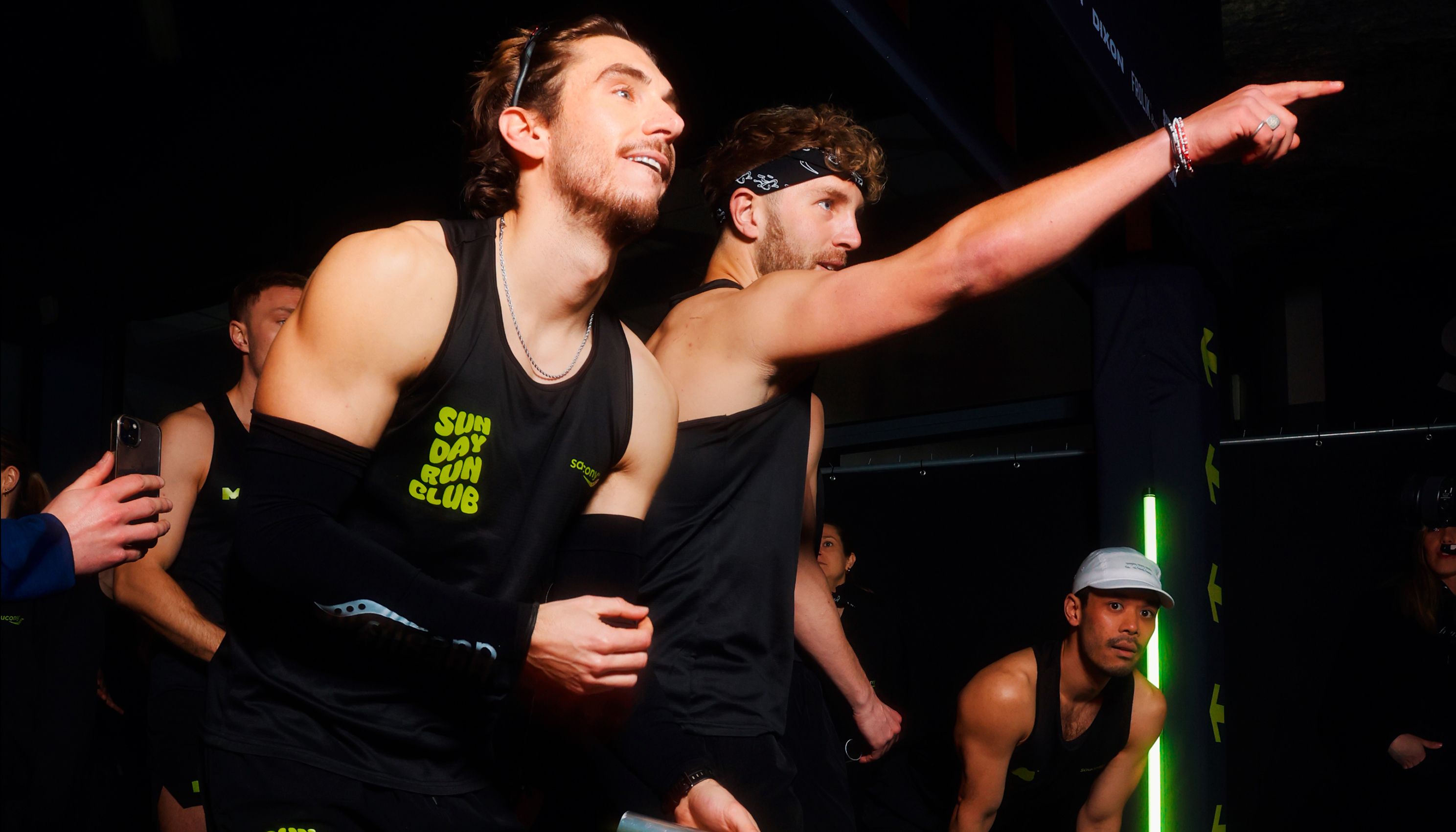 a group of men in black tank tops