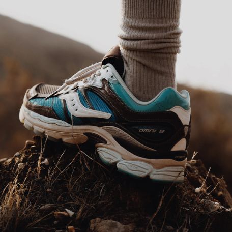 a person's foot in a blue and white tennis shoe