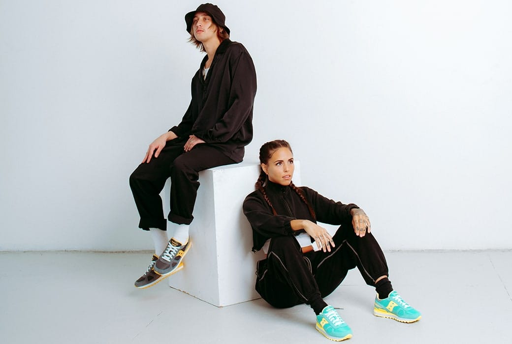 Two people possing with Saucony Shadow shoes.