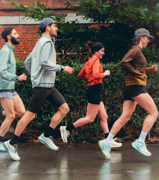 a group of people running on a sidewalk