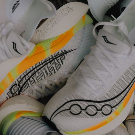 a pile of white and yellow shoes