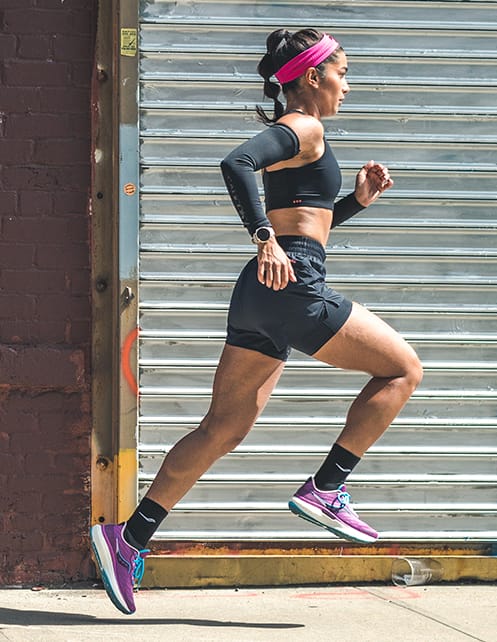 Woman running wearing Saucony Triumph 19 shoes.