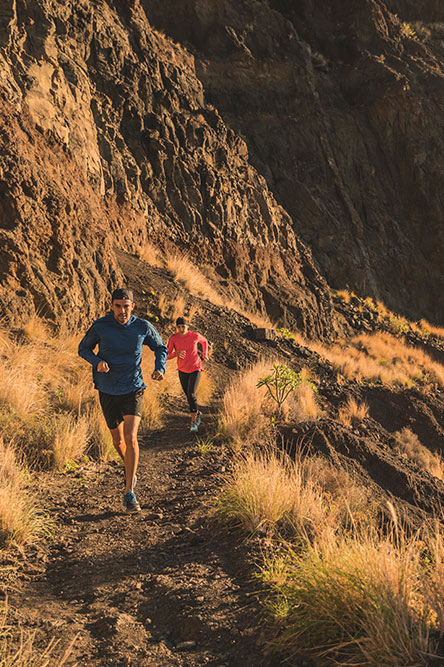 Man and woman running on a mountain track