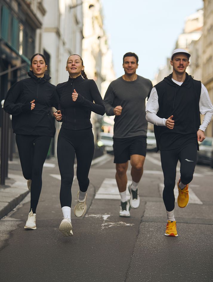 a group of people running on a street