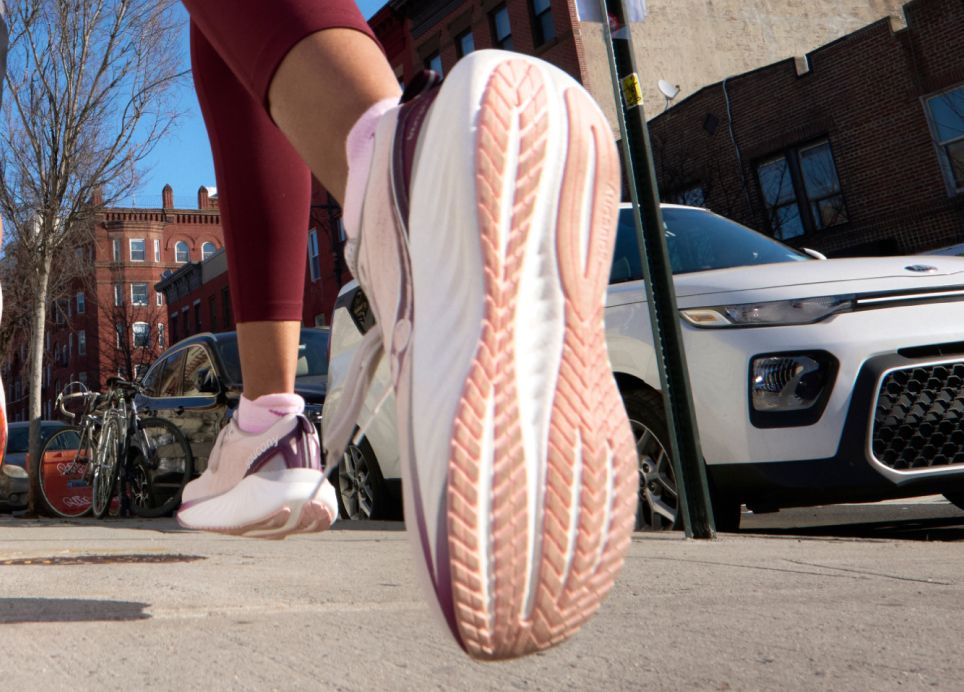 a person's foot in a pink and white shoe