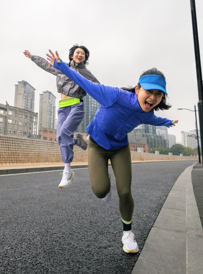 two women running on a street