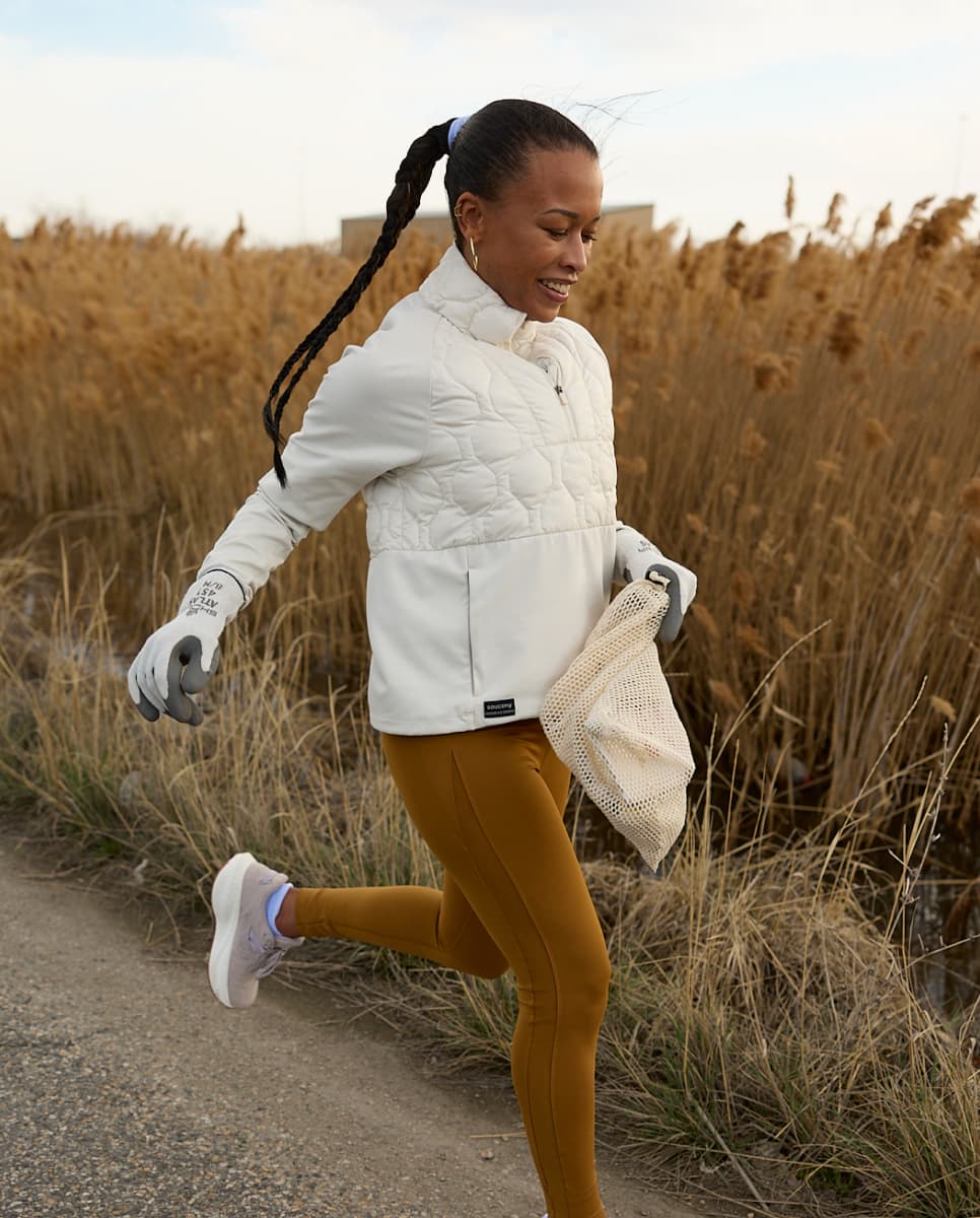 A woman running through a corn field