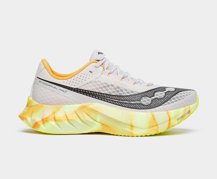 a white shoe with yellow and orange design