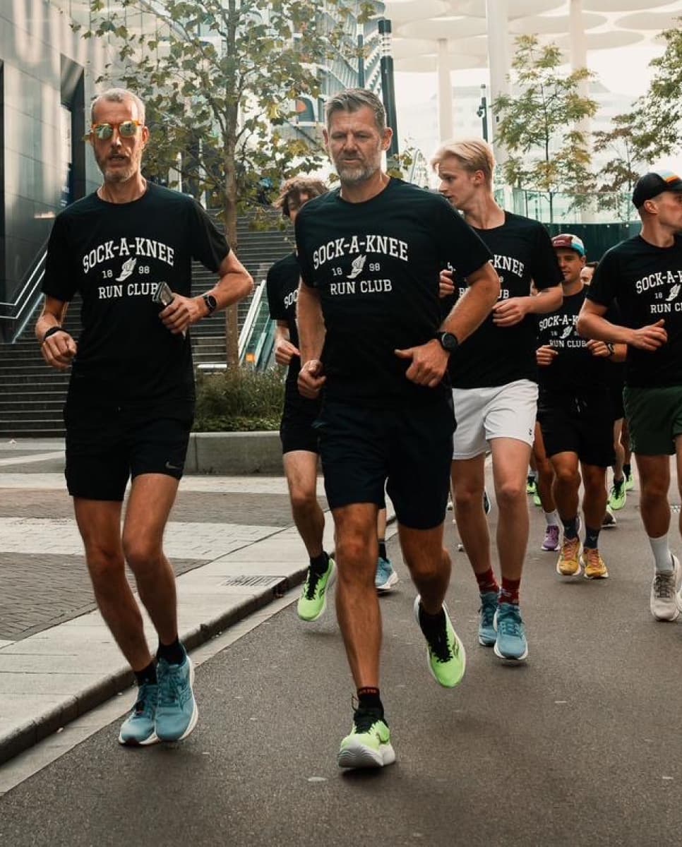 A group of runners, running down the street