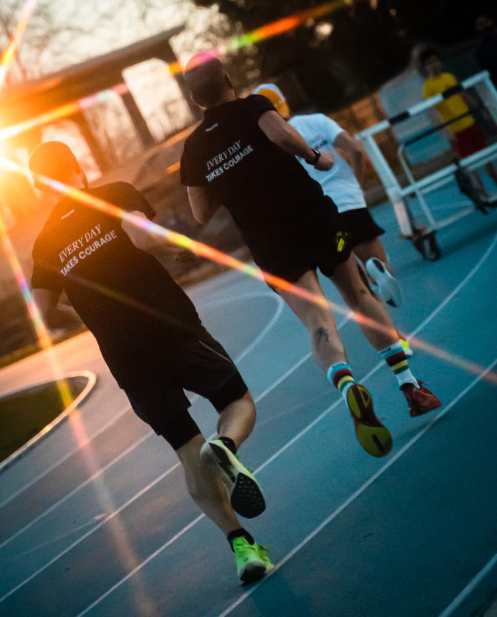 Three runners on a track