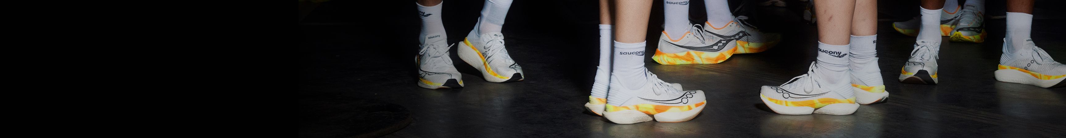 a pair of feet in white socks and white shoes