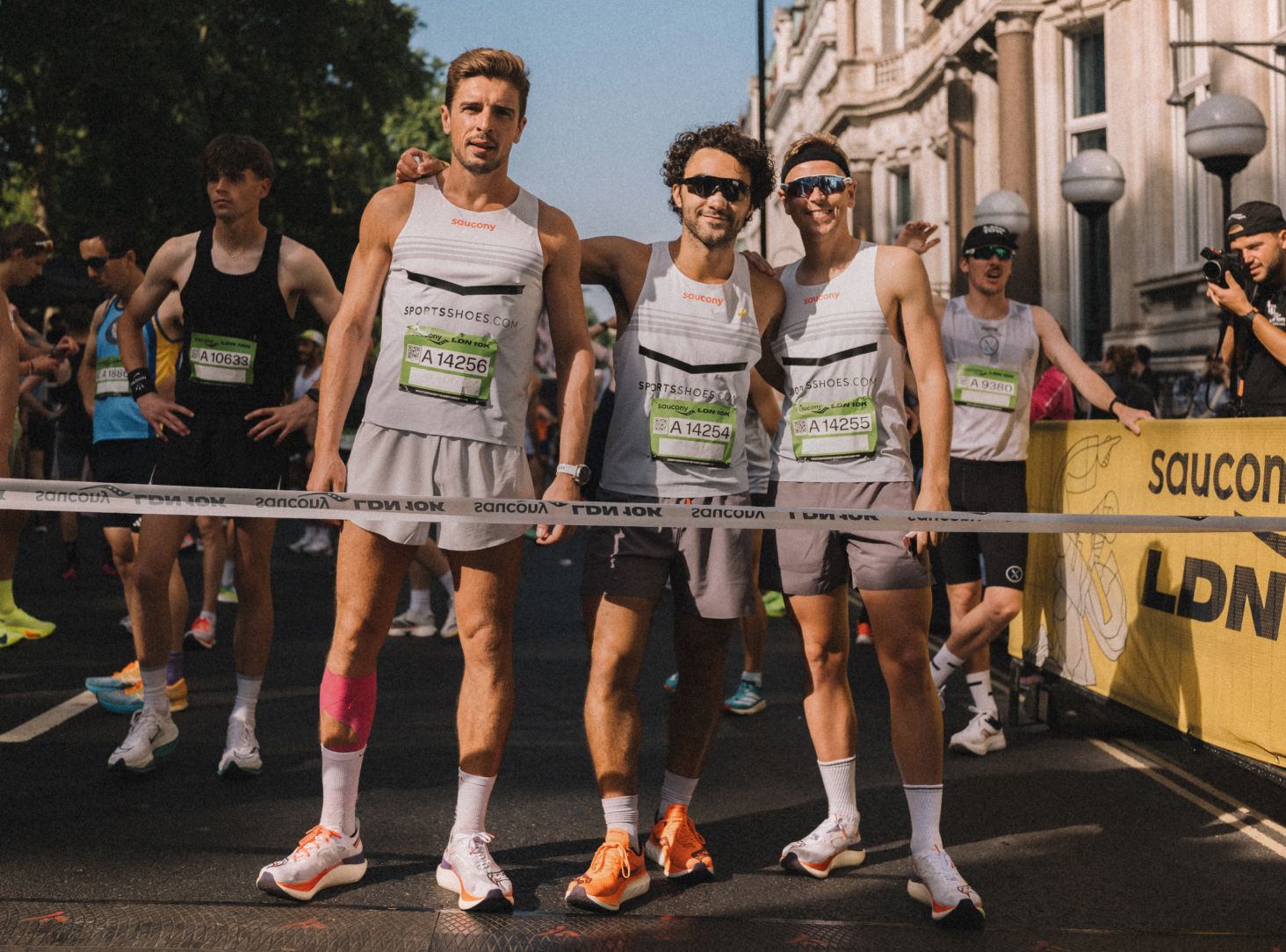 a group of men in running uniforms
