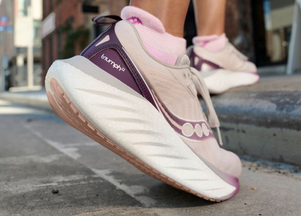 a person's foot in a pink and white shoe