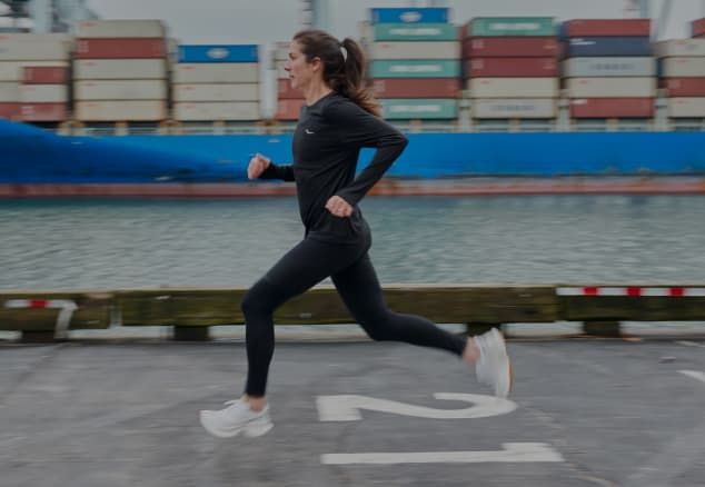 A group of runners, running down the street