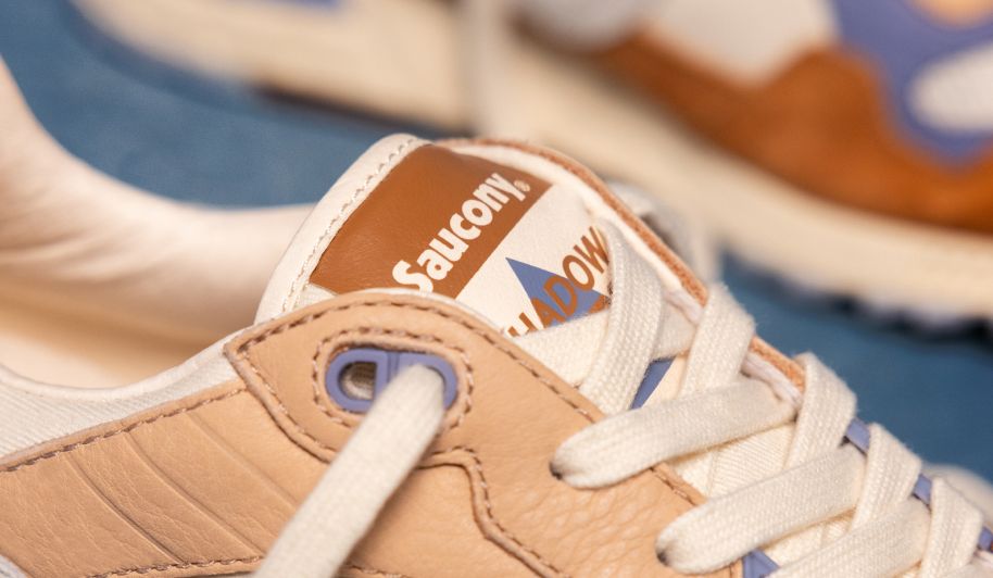 a brown and white sneaker on a brown couch