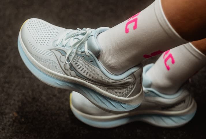 a person's feet in yellow and white shoes