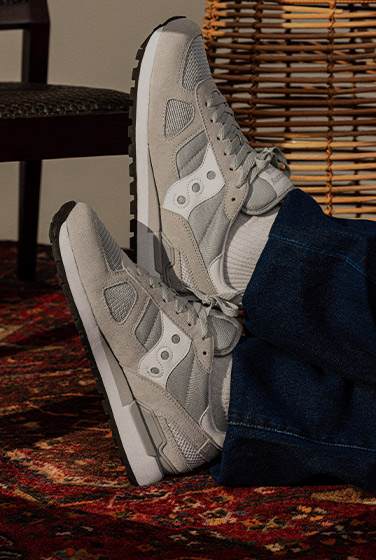 Relaxing while wearing white and grey Shadow sneakers.