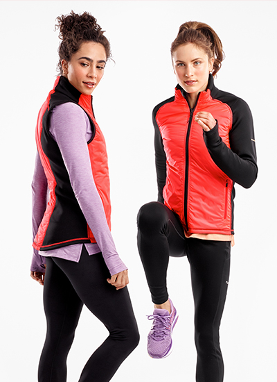 Women stretching and warming up in reflective Saucony apparel.