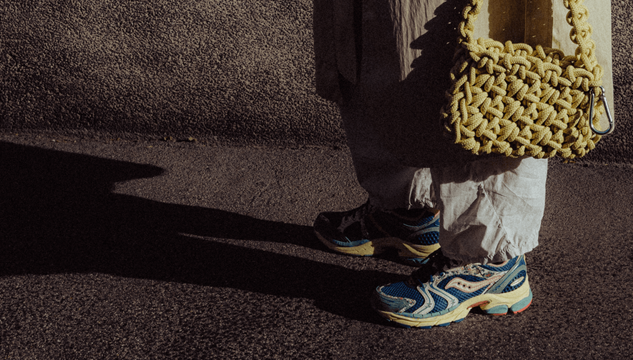 Person wearing ProGrid Triumph 4 Kissaten shoes walking on a sidewalk