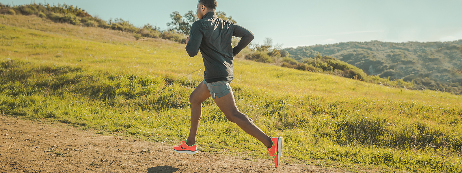 Runner climbs a hill.
