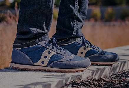 Closeup of a pair of Saucony Jazz Low Pro Vegans being worn by a pair of feet.