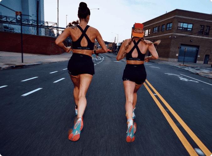 Two people running down the road.