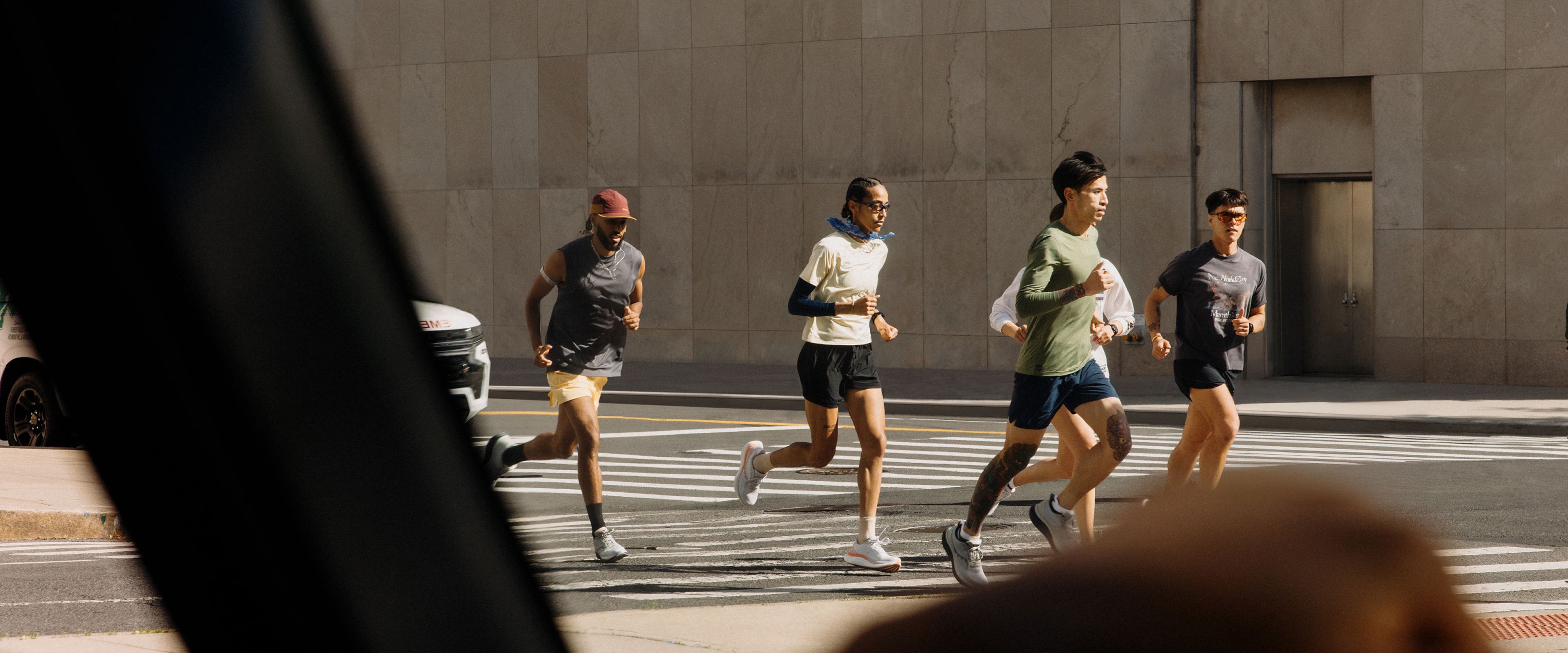 A group of people wearing saucony shoes running