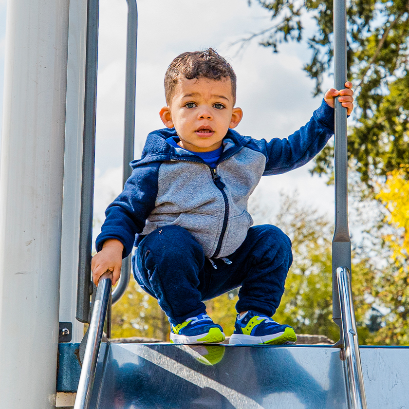 Kid at the top of a slide.