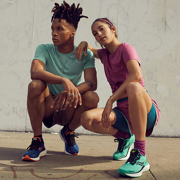 Man and woman wearing Saucony shoes and apparel