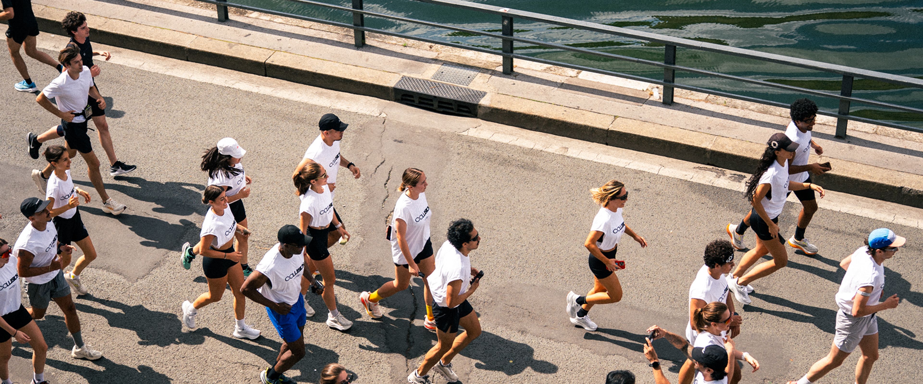 A group of people running accross a bridge