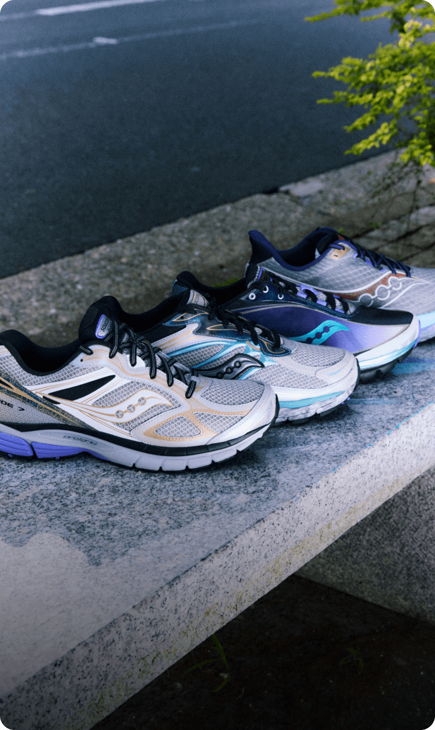 Kinvara 1, ProGrid Omni 9, and ProGrid Guide 7 shoes from the Daikanyama capsule collection lined up on a concrete curb.