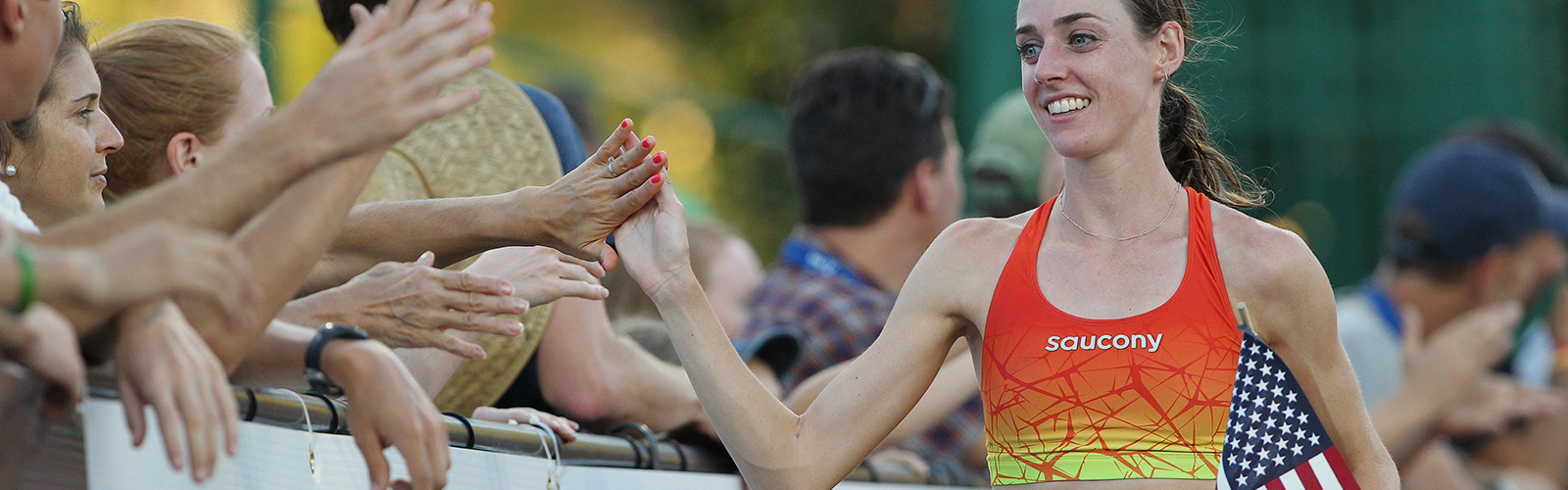 Woman giving high fives at the end of a race