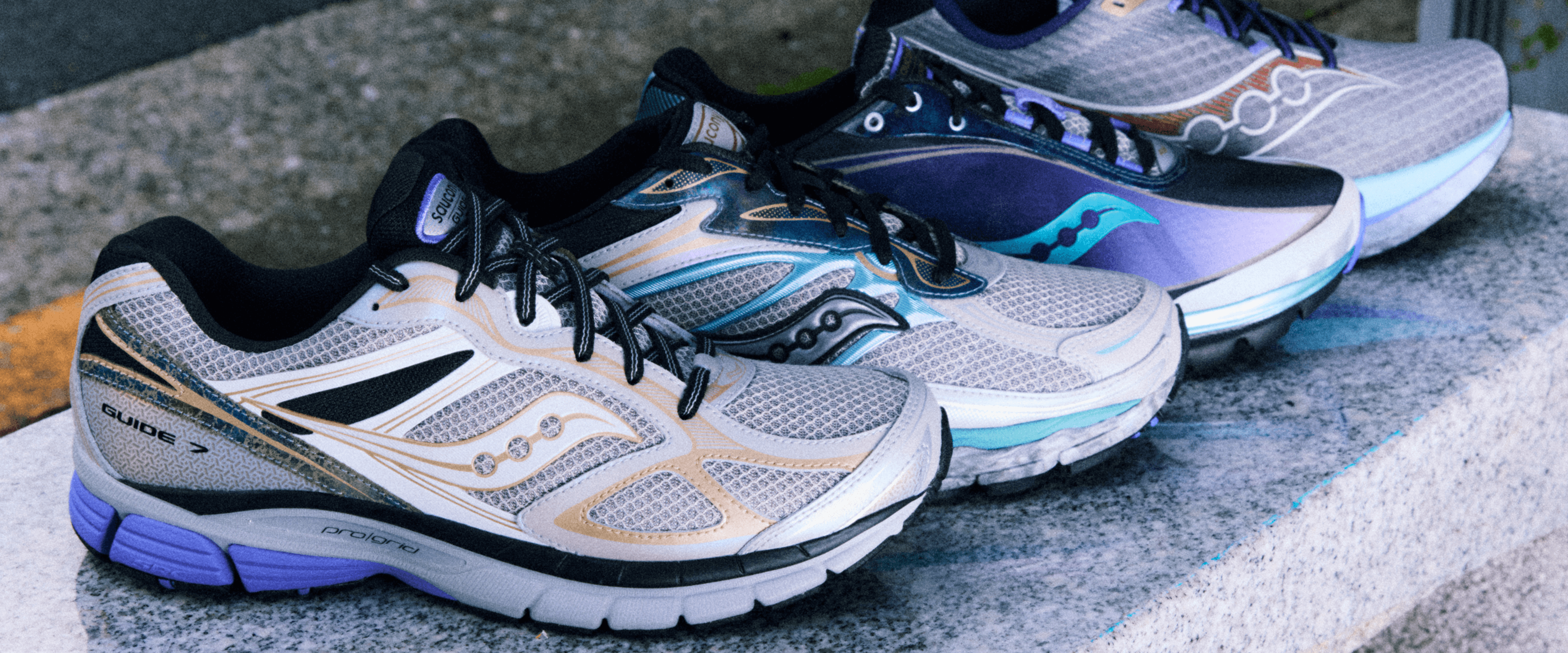 Kinvara 1, ProGrid Omni 9, and ProGrid Guide 7 shoes from the Daikanyama capsule collection lined up on a concrete curb.