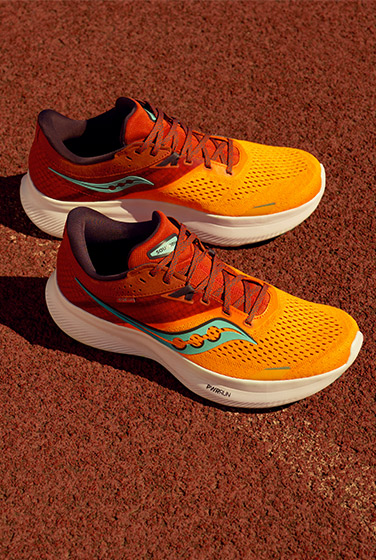 Red and orange Ride 16s on a running track.