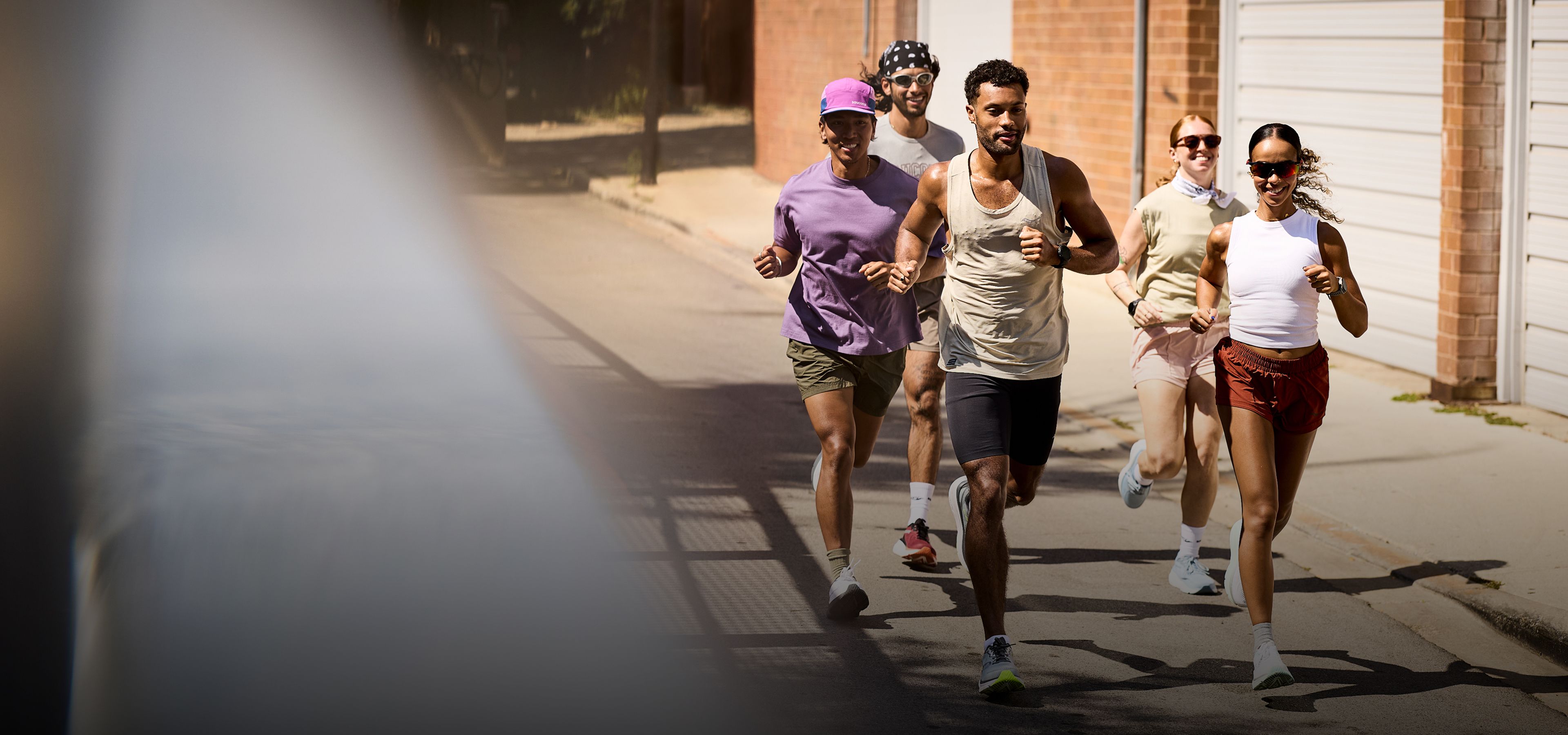 A group of people running down the street.