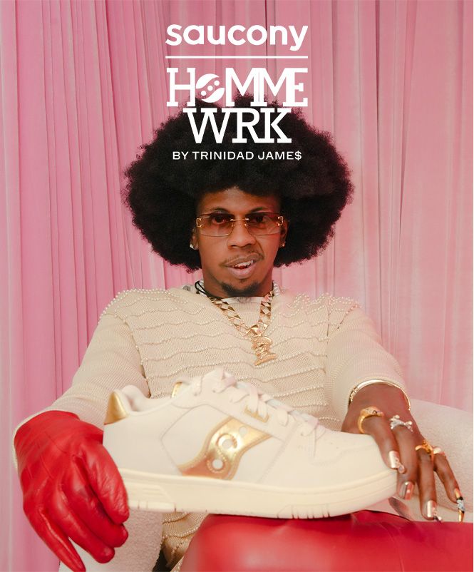 Trinidad James holding a Saucony Hommewrk sneaker and looking at the camera.