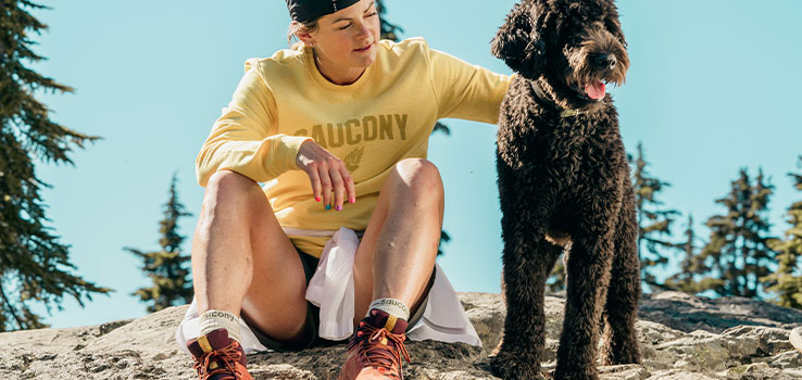A very cute and fluffy dog taking it's human for a hike.