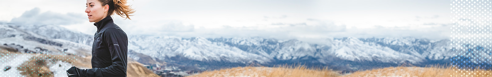 Woman running in the mountains in winter.